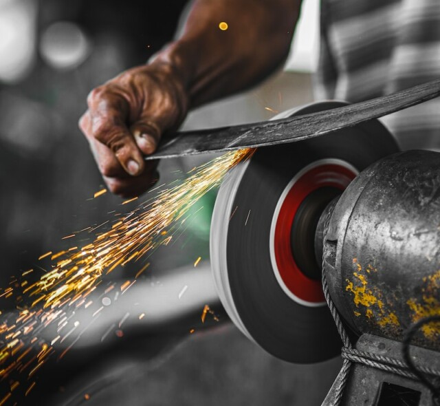 person holding black and red round metal